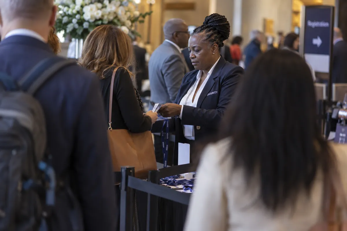 Illustrative private security work in Louisville, Kentucky: Black female officer working conference registration checkpoint