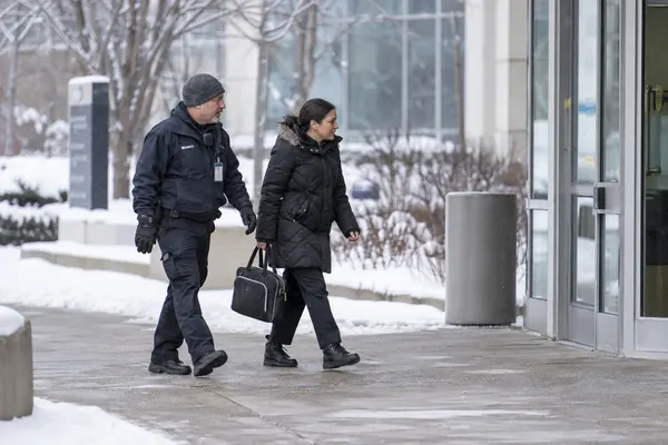 Illustrative private security work in Minneapolis, Minnesota: Male officer escorting visitor toward medical-campus doorway