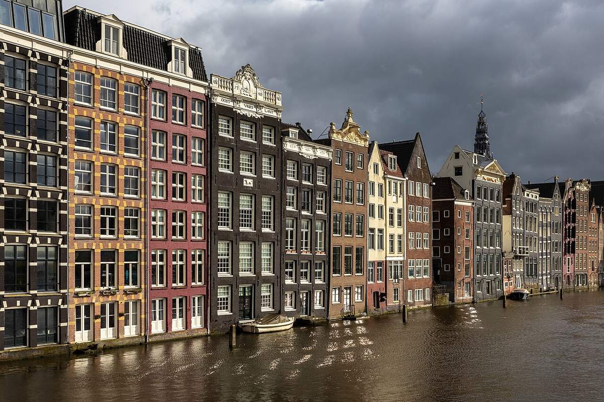 Canal houses along Damrak in Amsterdam, Netherlands